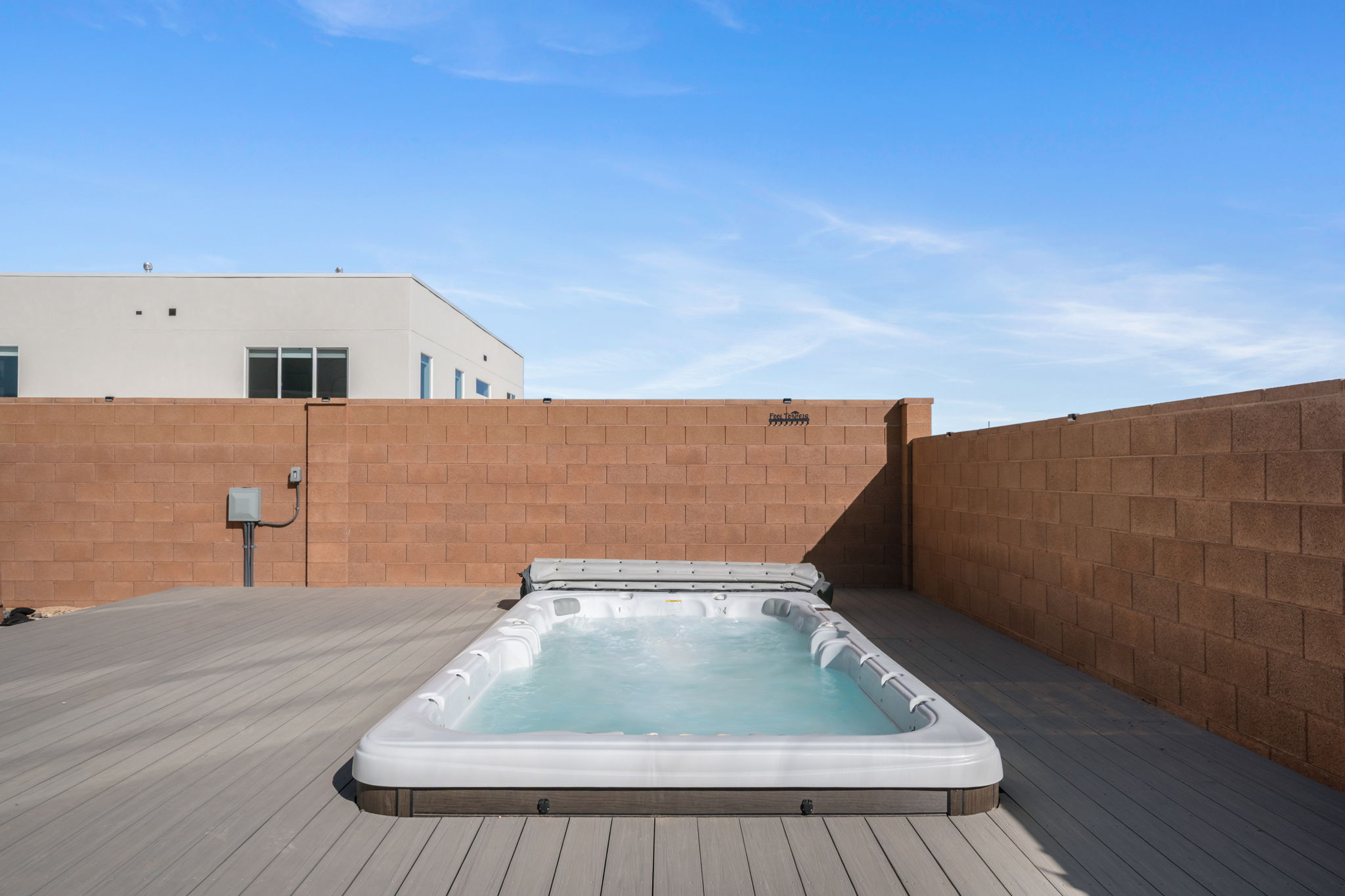 View of pool with a roof deck and a fenced backyard