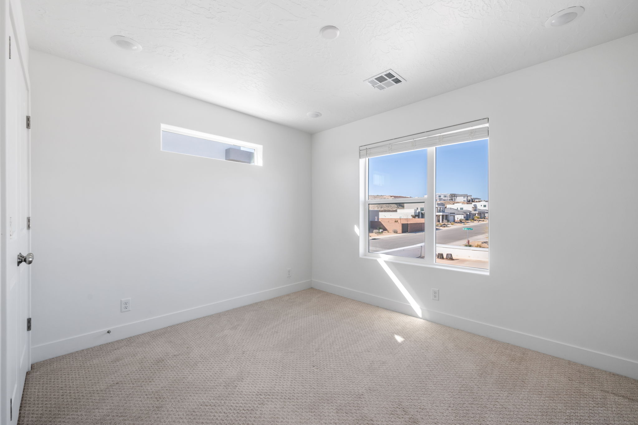 Carpeted empty room featuring plenty of natural light