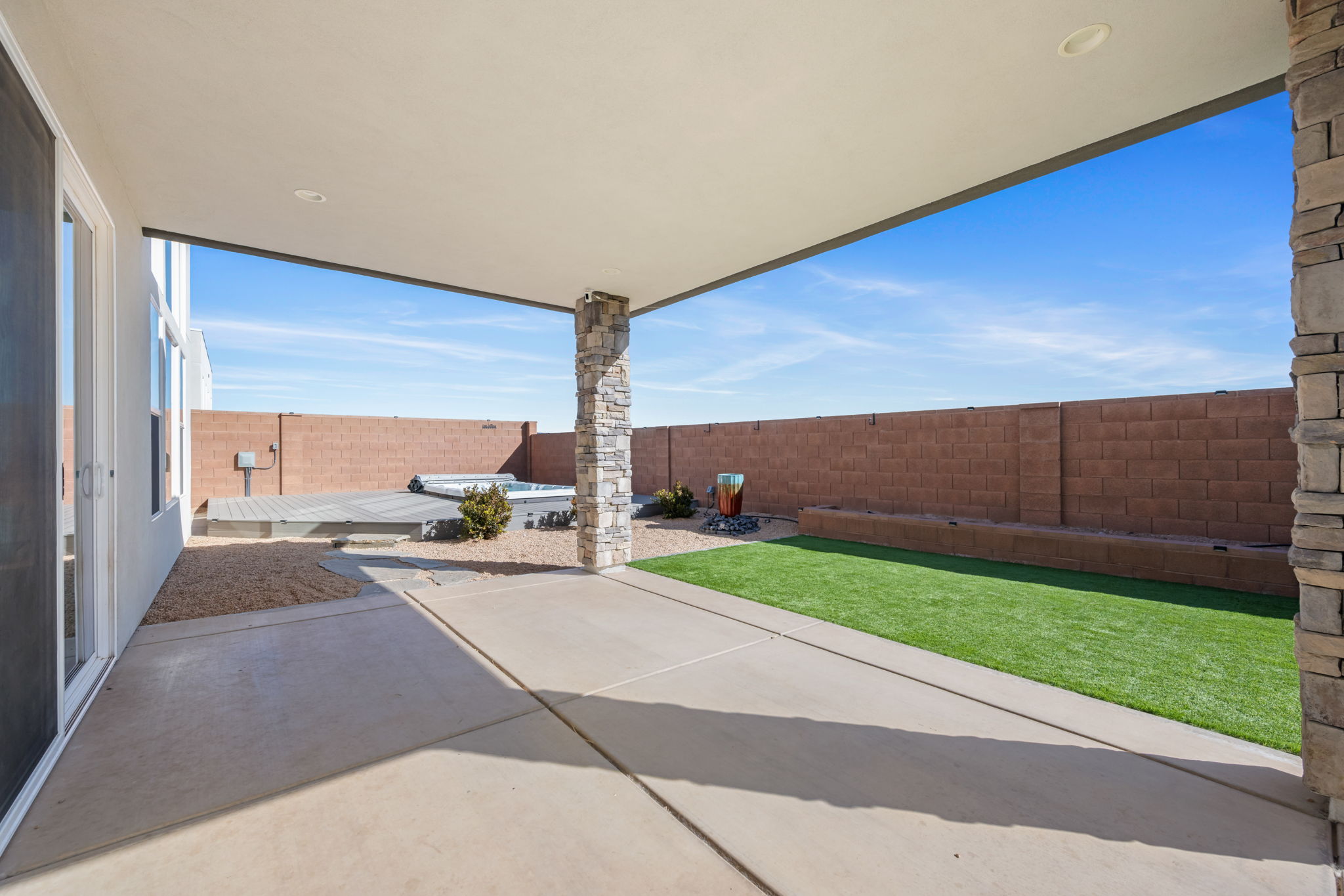 Fenced backyard with a patio area