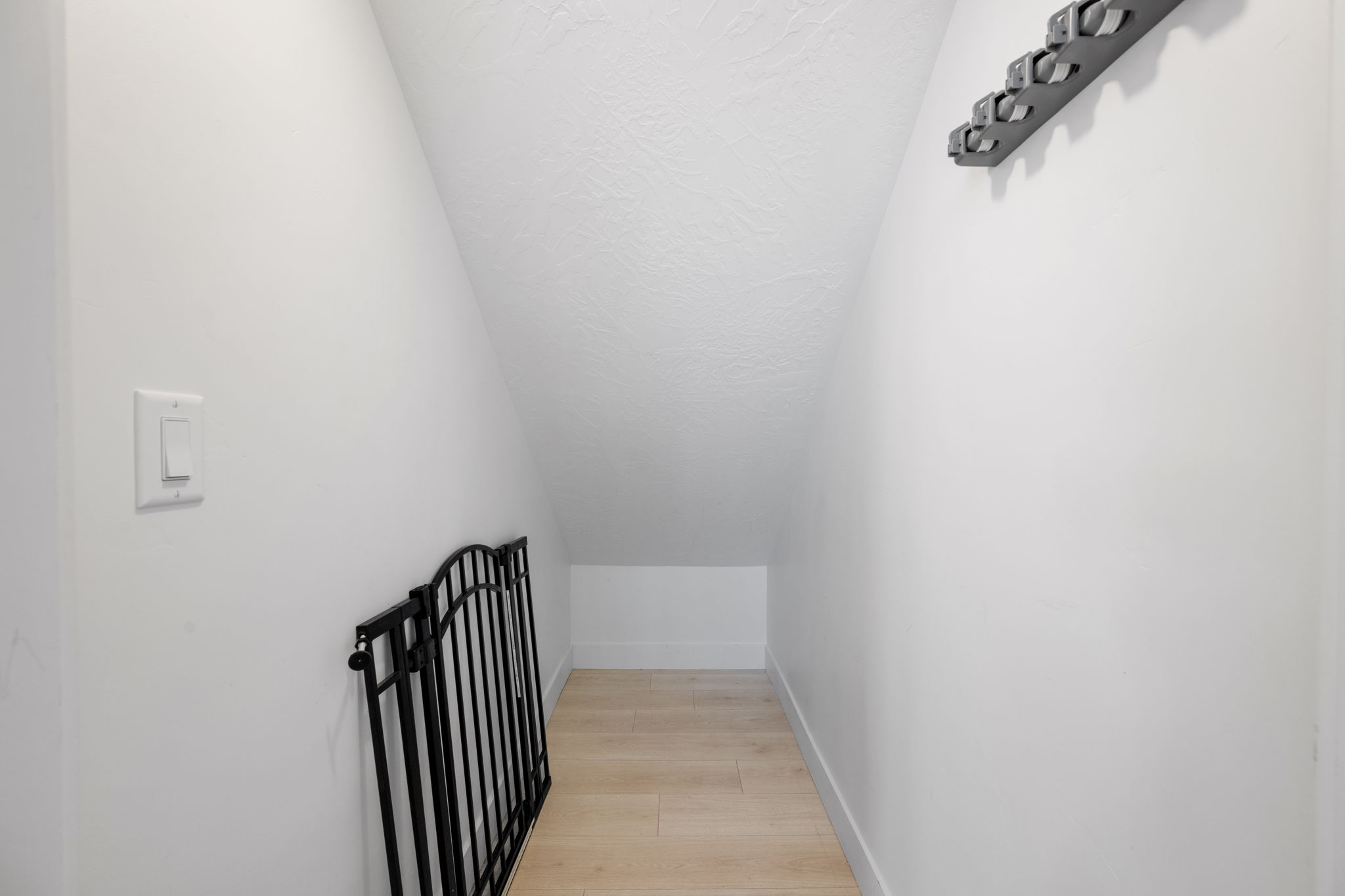 Staircase featuring wood finished floors and a textured ceiling