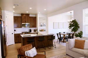Living Room opens up top a Great Room Design into Kitchen and Dining Areas