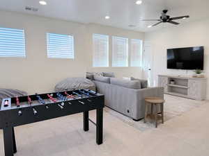 Recreation room with recessed lighting, a ceiling fan, and light carpet