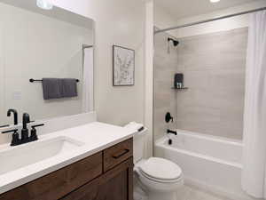 Bathroom with vanity, shower / tub combo, and light tile patterned floors