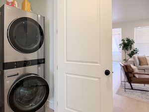 Laundry area featuring stacked washing machine and dryer