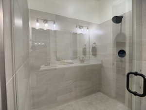 Full bath with a stall shower and a sink