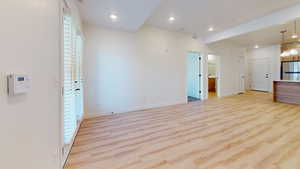Unfurnished living room with light wood-style flooring and recessed lighting