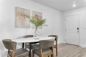 Dining area featuring baseboards and light wood-type flooring