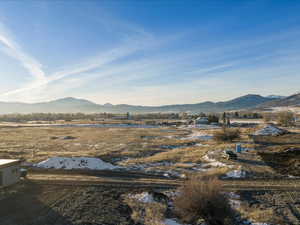 View of mountain backdrop with rural landscape