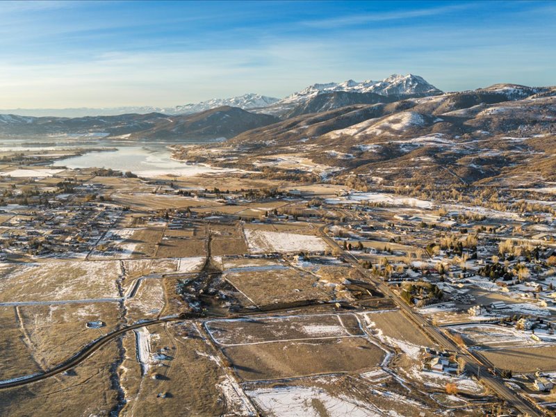 View of property location with a mountain backdrop and nearby suburban area