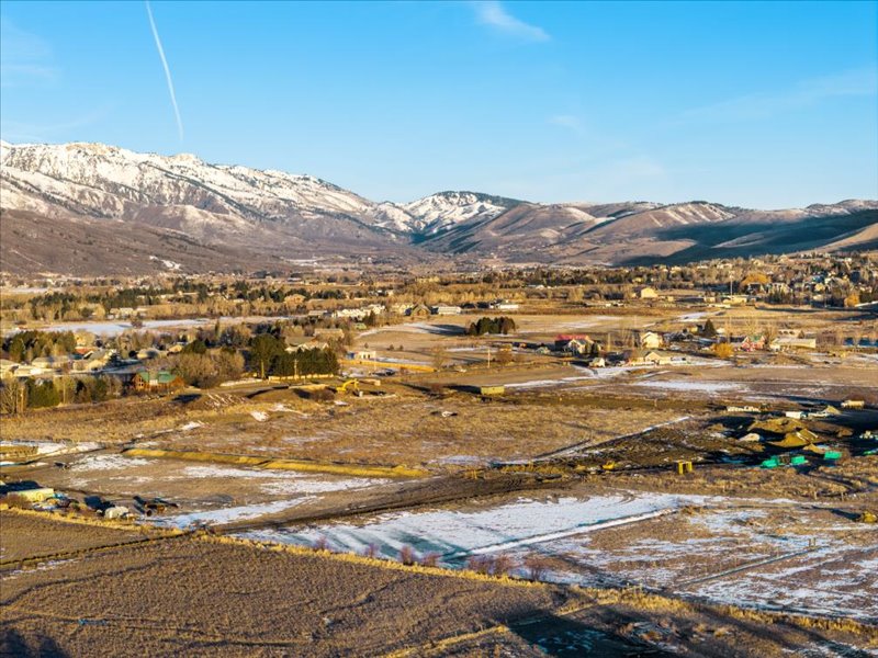 View of mountain backdrop with rural landscape