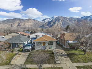 View of front facade with a mountain view, concrete driveway, and a residential view