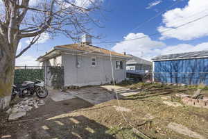 Rear view of house with brick siding and a chimney