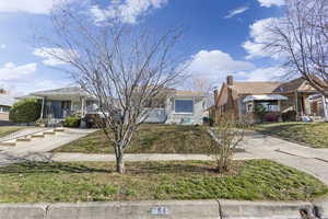 Bungalow-style home with a porch and a front yard
