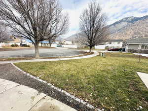 View of grassy yard featuring a residential view and a mountain view