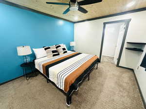 Bedroom with light carpet, ceiling fan, and wood ceiling