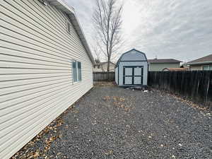 Fenced backyard with a storage unit