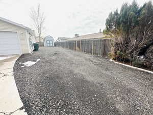 Fenced backyard with a storage unit