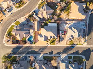 Aerial view of property and surrounding area featuring nearby suburban area