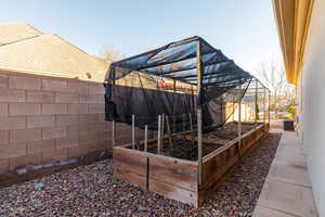 Wooden terrace featuring a vegetable garden