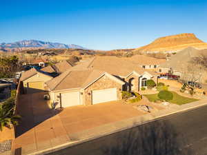 Ranch-style house featuring a garage, a mountain view, a residential view, and concrete driveway