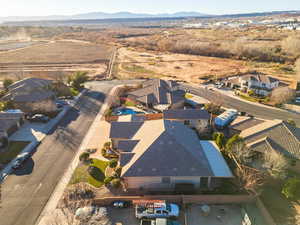 Aerial overview of property's location with nearby suburban area and mountains