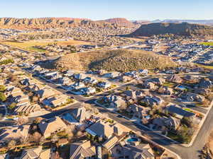 Aerial overview of property's location featuring a mountainous background and nearby suburban area