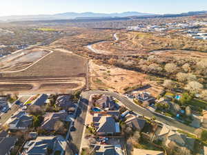 Aerial overview of property's location with nearby suburban area and a mountain backdrop