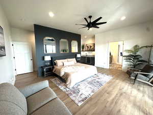 Bedroom featuring light wood finished floors, a ceiling fan, and recessed lighting