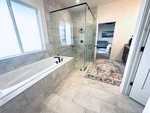 Ensuite bathroom with a bath, a stall shower, vanity, light tile patterned floors, and recessed lighting