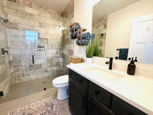 Full bathroom with vanity, a shower stall, and light tile patterned floors