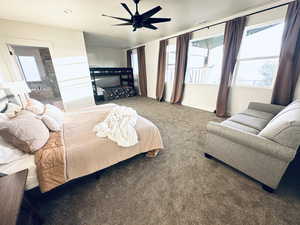 Carpeted bedroom with baseboards and ceiling fan