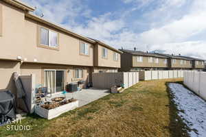 Rear view of house featuring a fire pit, stucco siding, a patio area, a fenced backyard, and a residential view