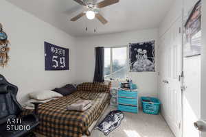 Bedroom featuring carpet flooring, a closet, and ceiling fan