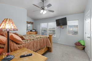Bedroom featuring light carpet, vaulted ceiling, and ceiling fan
