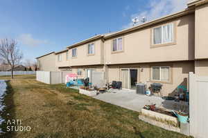 Rear view of house featuring a patio and stucco siding