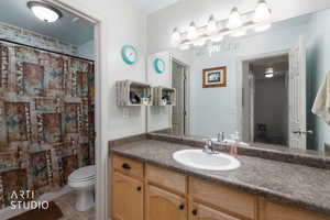 Bathroom featuring vanity, curtained shower, and light tile patterned floors