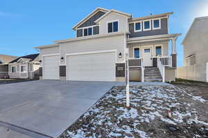 View of front facade with covered porch, concrete driveway, and a garage
