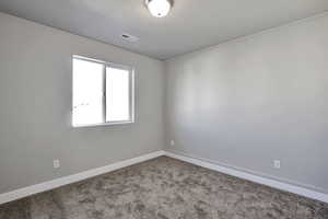 Spare room with baseboards and carpet flooring