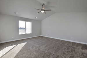 Unfurnished room with light carpet, vaulted ceiling, and ceiling fan