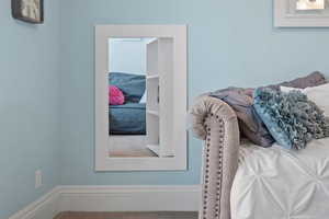 Access to hidden lounge behind swiveling bedroom bookshelf