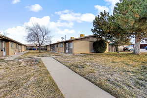 View of side of property featuring a residential view, and brick siding