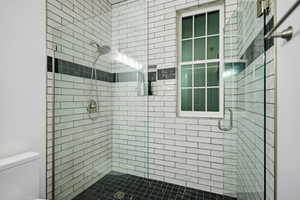 Bathroom with a stall shower and toilet