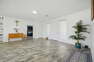 Foyer entrance featuring baseboards