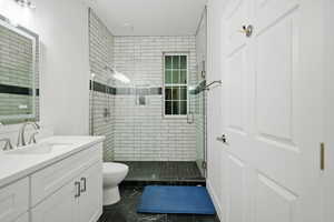 Bathroom featuring a shower stall and vanity