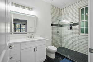 Bathroom with a shower stall and vanity