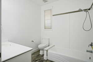 Full bathroom with vanity, shower / bathtub combination, and dark wood finished floors