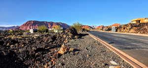 View of asphalt street with a mountain view and curbs