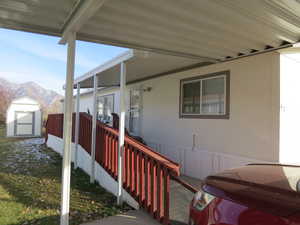 View of property exterior with a storage shed and a mountain view