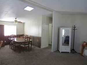 Carpeted dining space with a ceiling fan