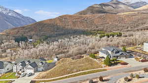View of mountain backdrop featuring nearby suburban area
